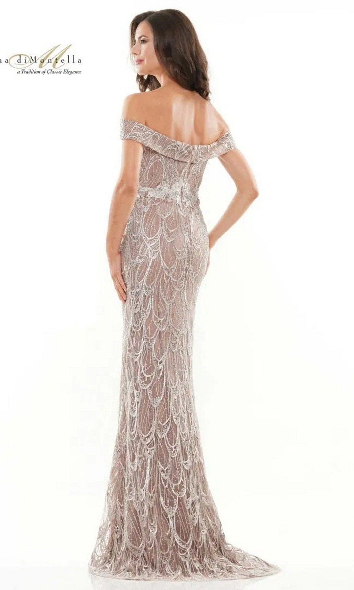 A woman faces away, highlighting the Long Formal Dress: Rina Di Montella RD2739—an off-the-shoulder, floor-length gown with beaded embroidery, a fitted silhouette, and intricate scalloped patterns—against a plain white background.